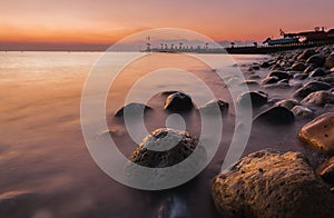 Coastal rocks in the sea before dawn