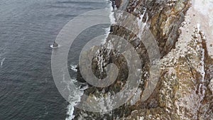 Coastal rocks at strong choppy sea.