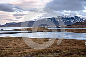 Coastal Scenery in Iceland with a Seaside Village at the Foot of a Majestic Mountain