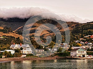 A coastal town of Akaroa in Canterbury region of New Zealand in the evening light