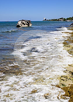 Coastal view of a shipwreck on the shore of Cozumel Beach, Mexico.