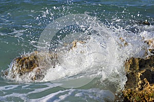 Sea wave is broken up by the coastal stones