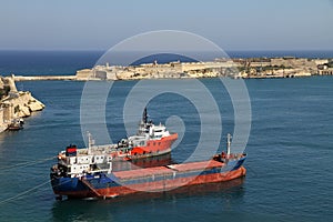 Coaster and tugboat in Valletta