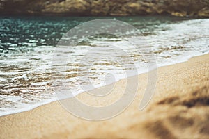 Coastline beach on sunny day background of ocean, gold sand close up blur, tourism relax calm concept, seascape perspective vacati