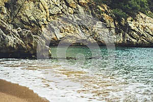 Coastline beach on sunny day background rocky coast, gold sand close up blur, tourism relax calm concept mockup, seascape perspect photo