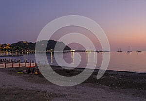 Coastline and city skyline at sunset in Sestri Levante, Liguria, Italy. City background, reflections