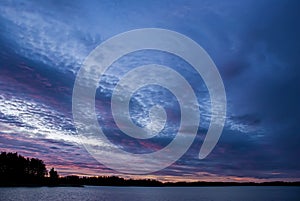 Coastline with cloudy sky in purple sunrise