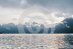 Coastline with cloudy sunset sky, sea and mountains in the Khao Sok National Park, Suratthani Thailand.