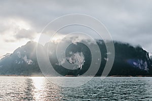 Coastline with cloudy sunset sky, sea and mountains in the Khao Sok National Park, Suratthani Thailand.