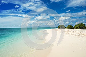 Coastline on the coral Atoll. Paradise tropical island, white sand and clear water. Landscape.