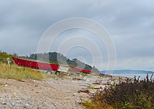 a coastline at the East Sea in Denmark with asmall red boat