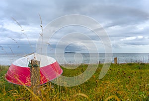 a coastline at the East Sea in Denmark with asmall red boat