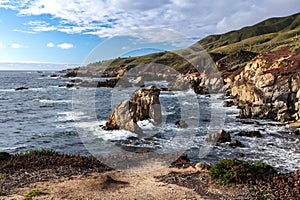 Coastline, Garrapata Beach, California. Rocky shore, waves, Large rocks just offshore. photo