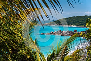 Coastline of La Digue island in Seychelles. Grand and Petite Anse paradise beaches with blue ocean lagoon between green