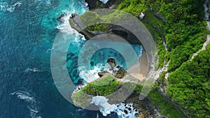 Coastline landscape with rocks and tropical ocean with waves in Indonesia. Aerial view