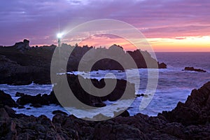 Coastline and lighthouse at dusk