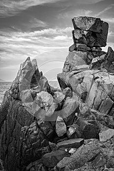 Coastline in Nha Trang Vietnam with rocky shore. Cliff and sea, rocky shore, rock formation, photo in black and white