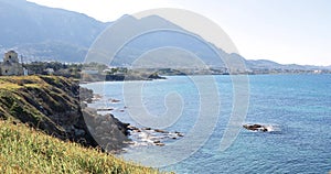 Coastline of northern part of island of Cyprus. View of Kyrenia mountains. The ruins of historic building. Splashes of