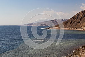 The coastline of the Red Sea and the mountains in the background. Egypt, the Sinai Peninsula. Coral reef Blue Hole