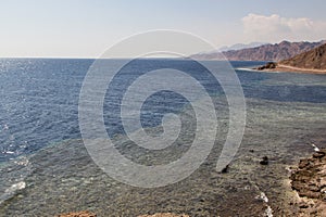 The coastline of the Red Sea and the mountains in the background. Egypt, the Sinai Peninsula. Coral reef Blue Hole
