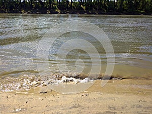 Coastline of a river with a sandy beach