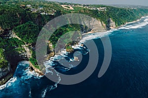 Coastline with rocks and ocean with waves in Bali. Aerial view