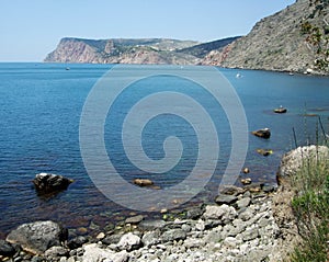 Coastline of sea with hills and stones on the beach. Black sea. Crimea