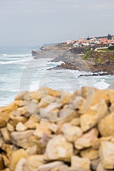Coastline with stones and surfs in cloudy day