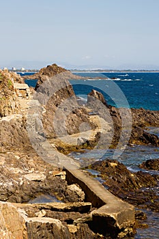 Rocky coasts with an old stone footbridge