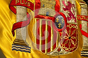 Coat of arms of Spain nation richly embroidered on its flag
