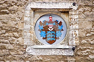The coat of arms on the wall of the Tallinn town hall, Estonia photo