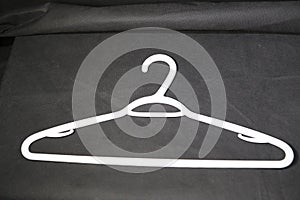 Coat hanger shown in white for the dry cleaning industry