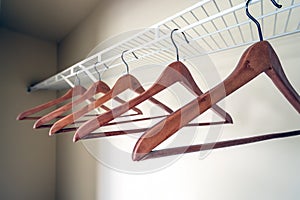 Coat hangers in an empty closet. photo