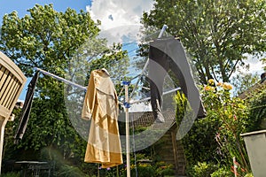 Coat and Pants Hang Drying in Sunny Green Backyard