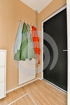 a coat rack in a living room with a door
