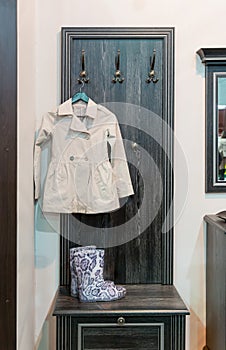 Coat and wellington boot