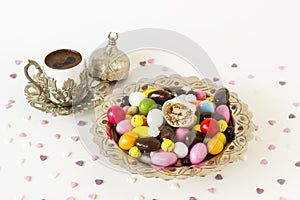 Coated almond candies,a slice of Traditional Turkish Delight and chocolates designed in vintage silver candy bowls