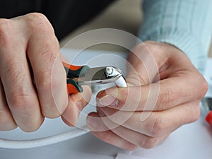 Coaxial cable to transmit satellite signals in hand. Closeup cable repair. photo