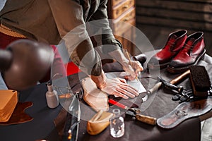 Cobber`s hands with a pencil on a desk