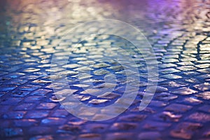 Cobble Stone Pavement - Reflexion in Urban Night. Wet Blue Sidewalk