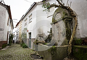 A cobbled street with an antique water fountain in Barroca village photo