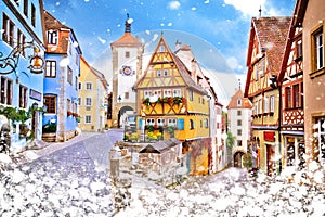 Cobbled street and architecture of historic town of Rothenburg ob der Tauber winter snow view