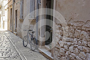 Cobbled street with old houses and bicycle