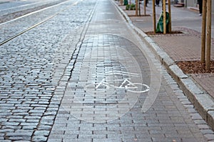 Cobbled street with tram rails and separate lanes for cyclists.