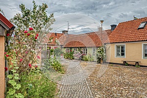 Cobbled town square in a small, touristic fishermen village in the Osterlen region shows a cosy neighbourhood and community