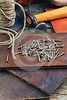 Cobbler's tools on a wooden background