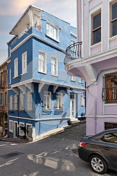 Cobblestone alley with beautiful old traditional blue house in Balat district, on a summer day, Istanbul, Turkey