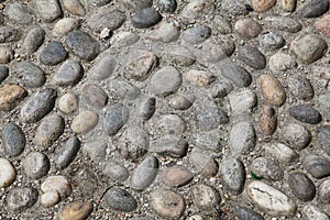 Old city pavement made of pebbles. Milan, Northern Italy, Europe