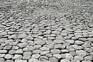 Cobblestone background with uneven natural stone