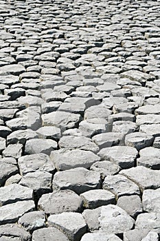 Cobblestone background with uneven natural stone